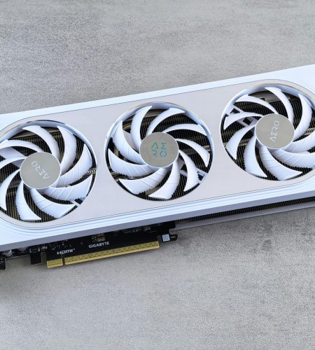 Stylish white graphics card with three cooling fans on a neutral background, ideal for tech enthusiasts.